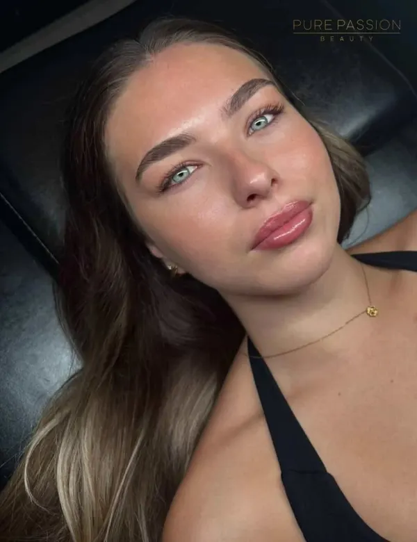 Client with blue eyes and undetectable healed lip blush